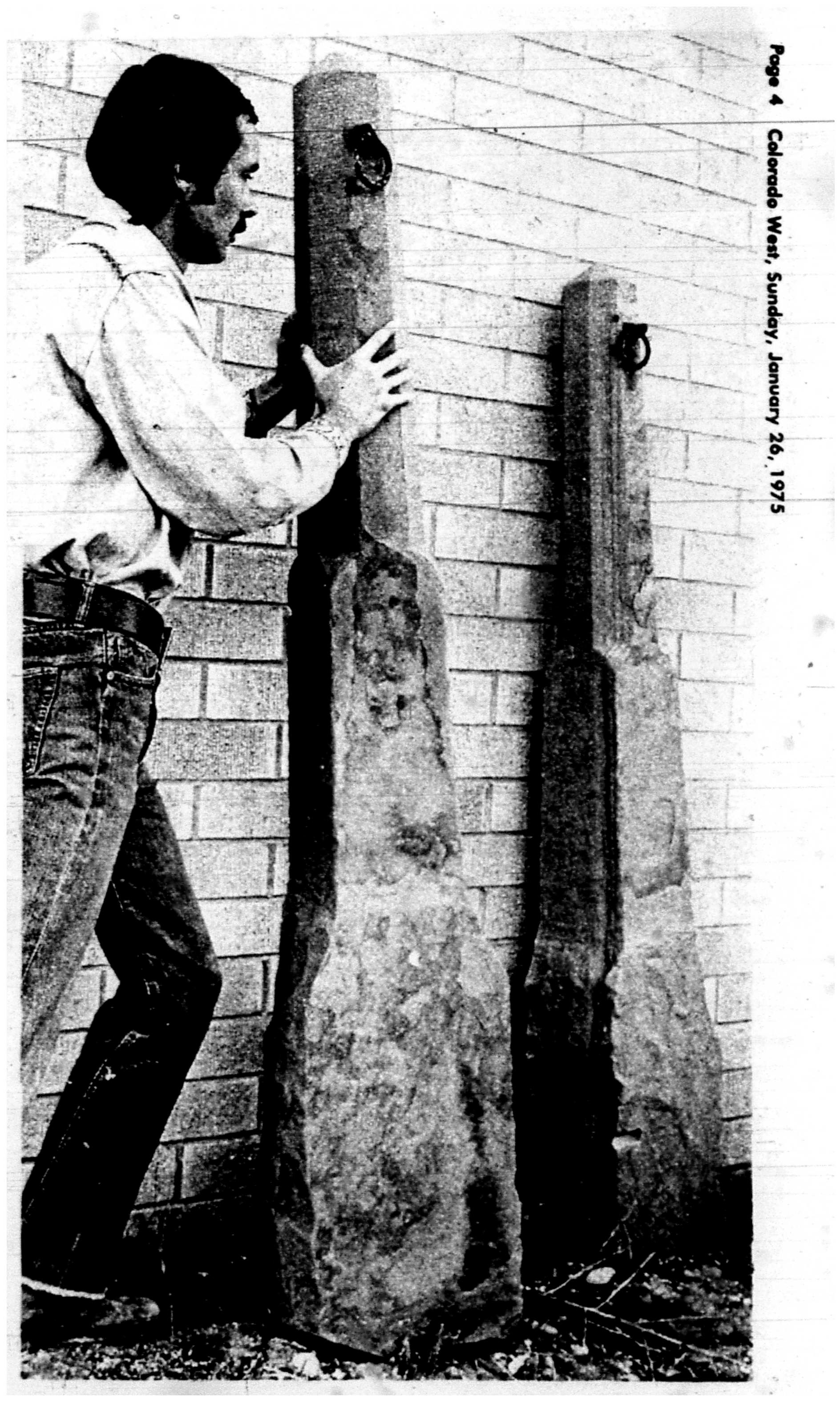 person holding up a hitching post.