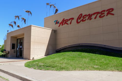 The Art Center exterior with metal bird sculptures attached to the roof