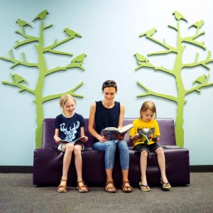 Picture of a family reading at the library.