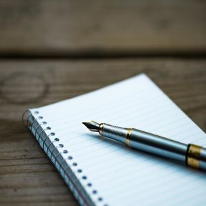 Picture of a pen laying on a notepad