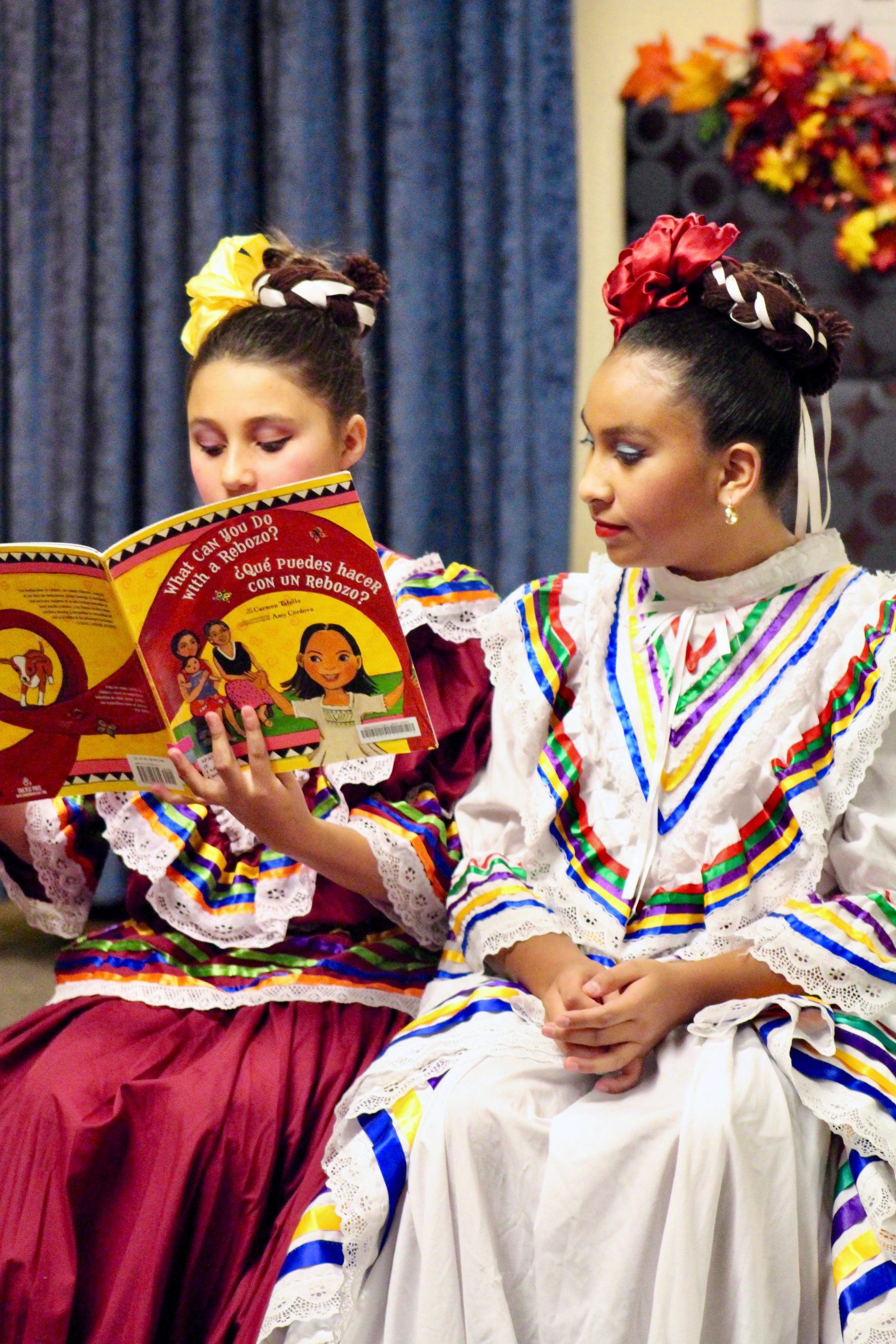 Two dancers reading a book