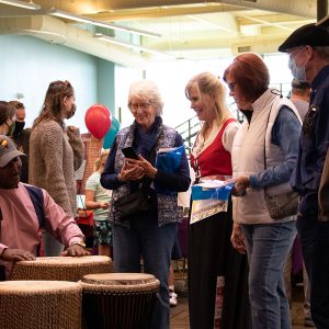 A group gathered around a Culture Fest presenter