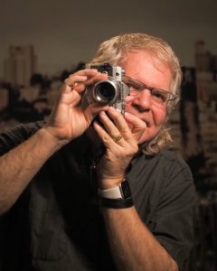 Artist in Residence Kyle Webb holding a camera