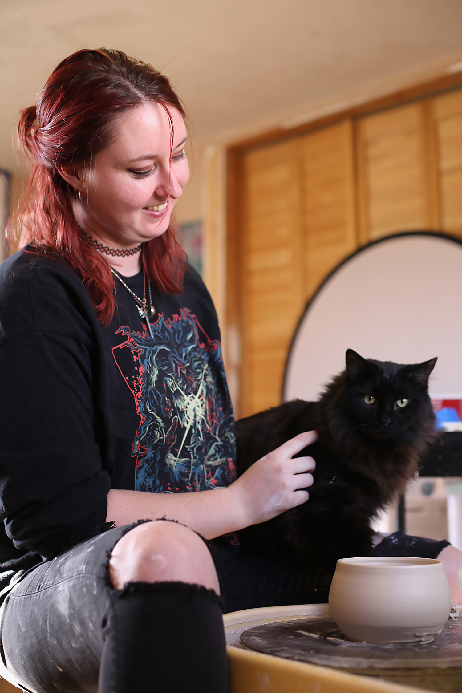 Artist in Residence Hannah Martin holding a cat