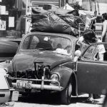 [PHOTO ID:] A man enters a car packed with his belongings as he prepares to leave B