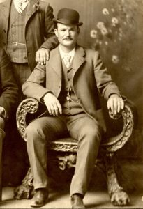 PHOTO ID: a seated Butch Cassidy wearing a bowler hat.