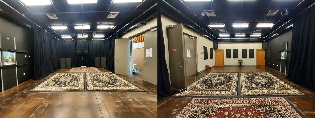 rectangular room with many rugs on the floor, soundproofing foam on walls and bright lights
