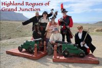 the highland rogues of grand junction, a group of seven people dressed in pirate costume with two small ball canons in front of them